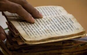 open hindu scripture book full of yoga terms