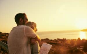 a couple stares out at a seascape
