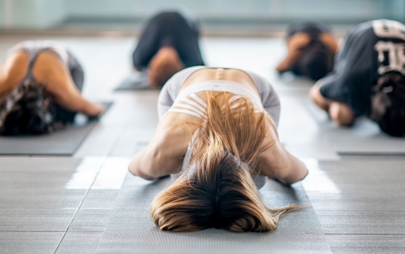 Premium Photo | Side view of a little girl in sportswear practicing yoga  doing dhanurasana exercise bow pose exercising in a yoga studio