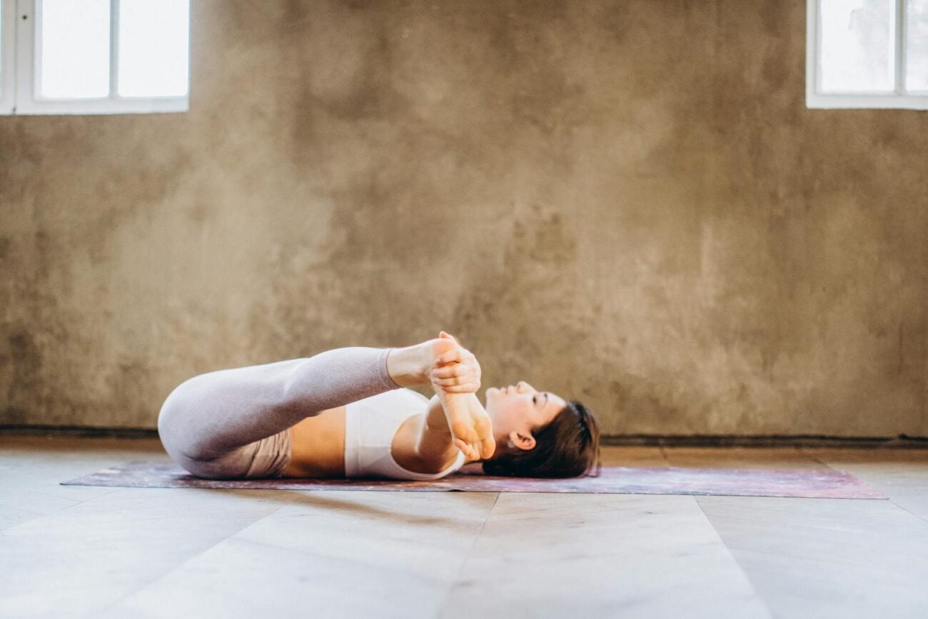 Woman practicing gentle restorative yoga to ease cancer-related fatigue during treatment