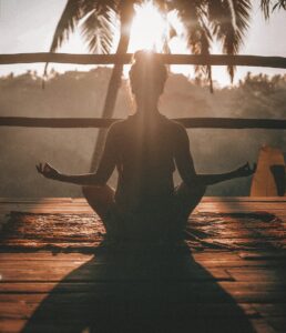 Woman practicing seated yoga breathing with eyes closed to support eye health