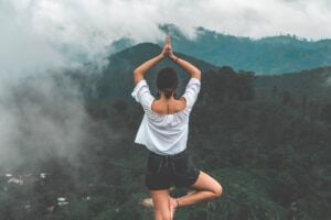 Person meditating in a peaceful yoga practice for tinnitus relief