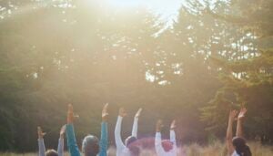 Older adults practicing mindfulness meditation in a yoga class setting