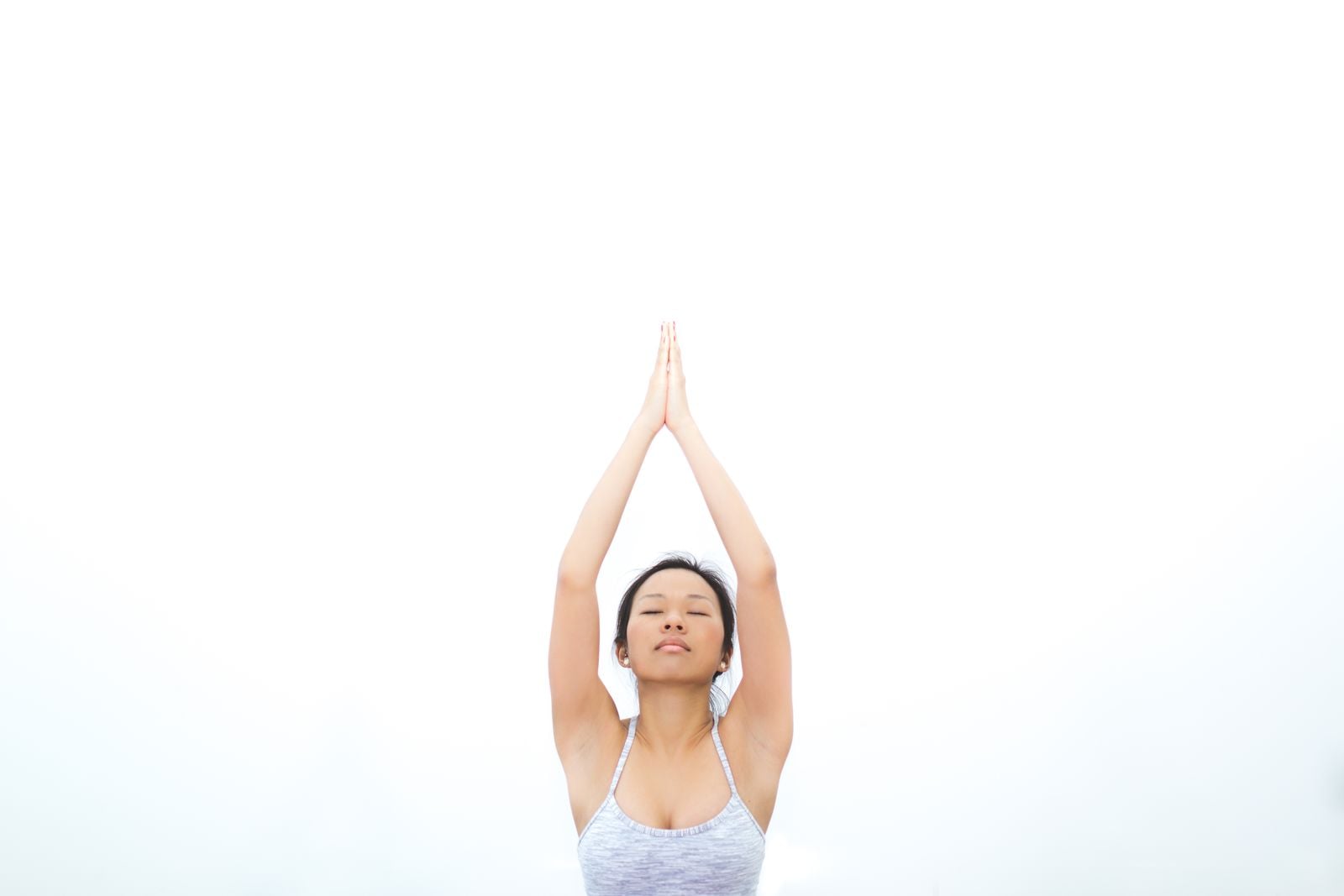 Woman practicing yoga outdoors with a calm expression, illustrating yoga for stress, anxiety and depression relief