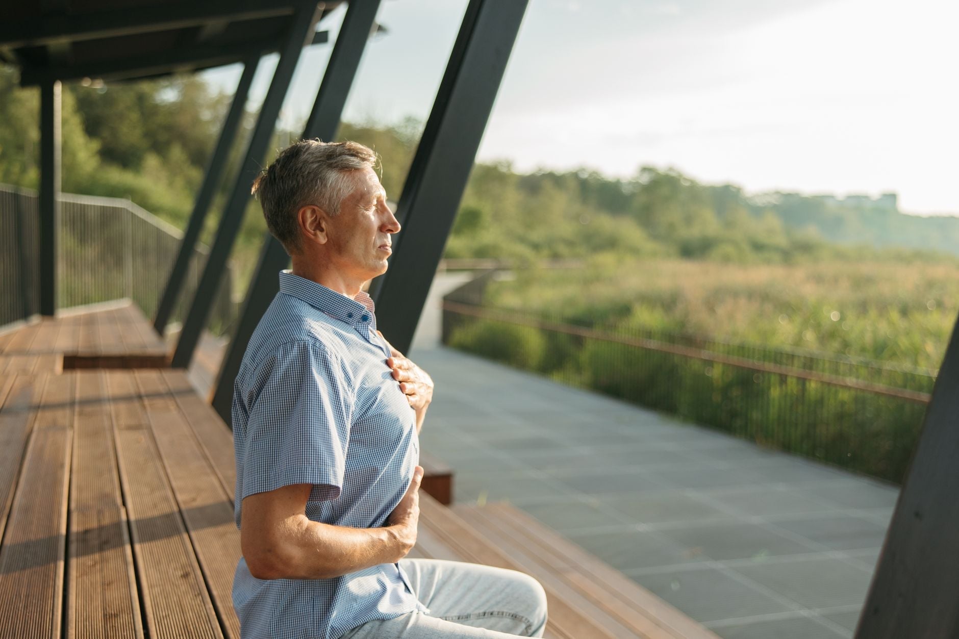 Woman sitting in quiet meditation with eyes closed, practicing yoga breathing to calm tinnitus