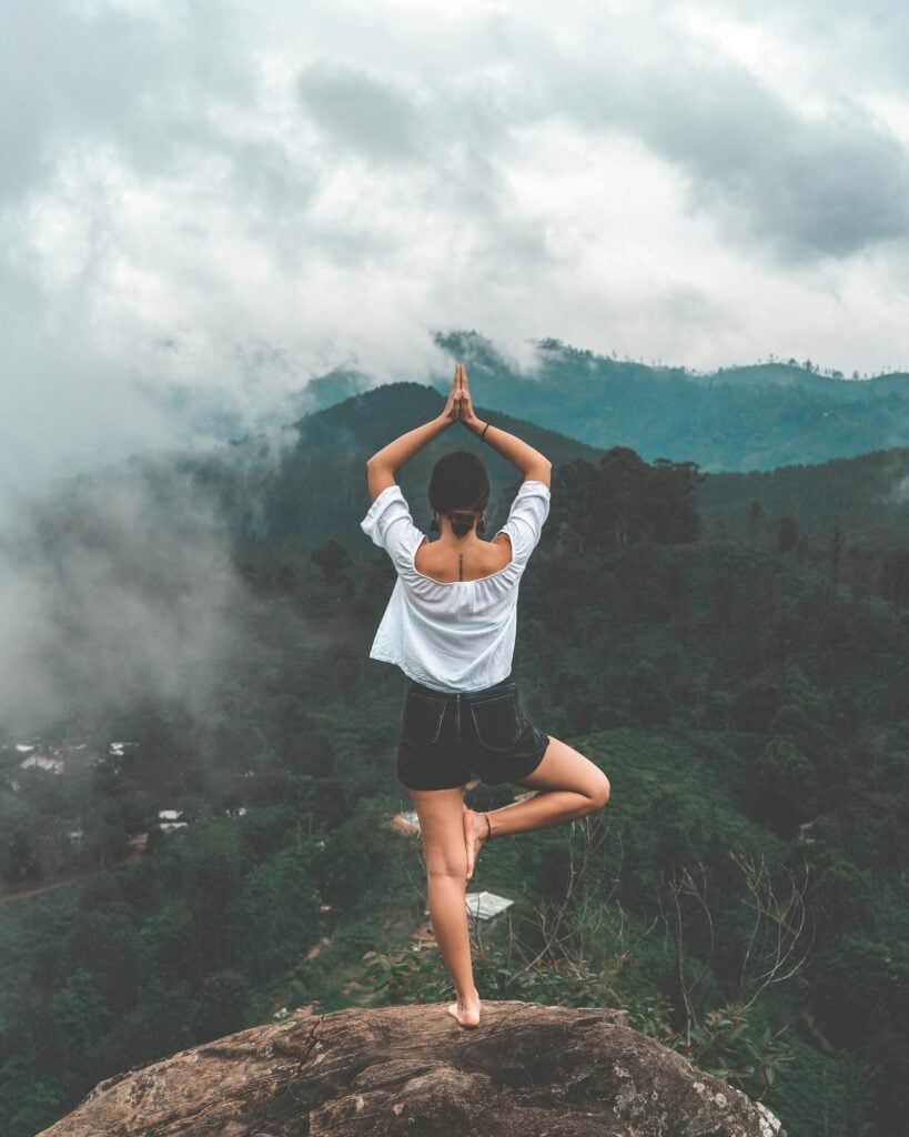 Mature woman doing yoga and stretching as part of varied exercise routine for longevity